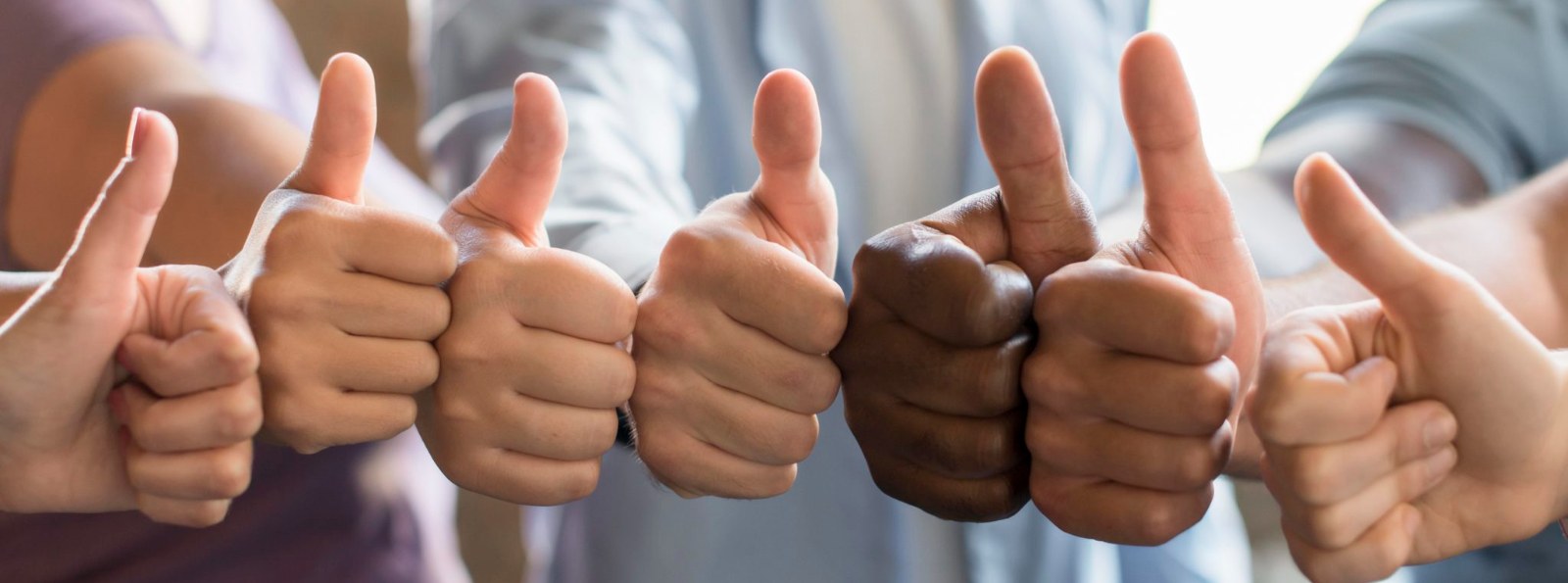 a group of people giving a thumbs up
